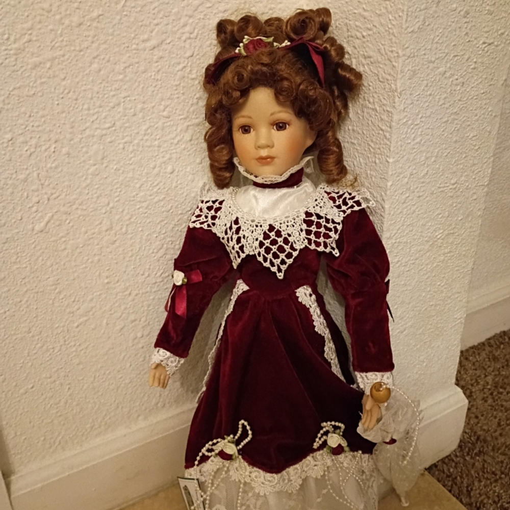 Classic Burgundy Porcelain Doll with Lace Details